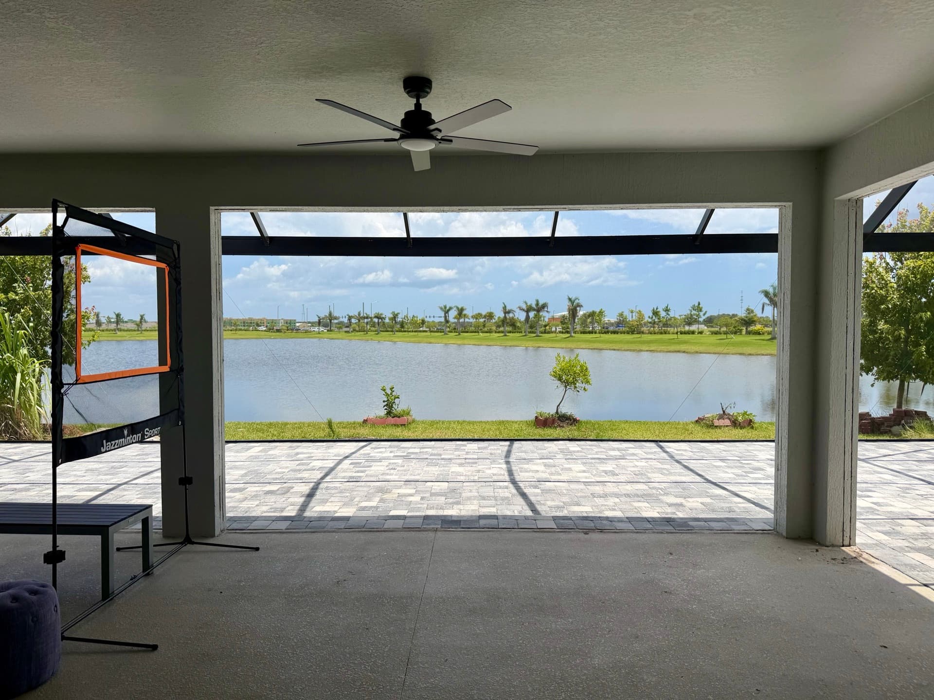 Unbroken lake view from under a panoramic screen enclosure with no vertical uprights in the sightline