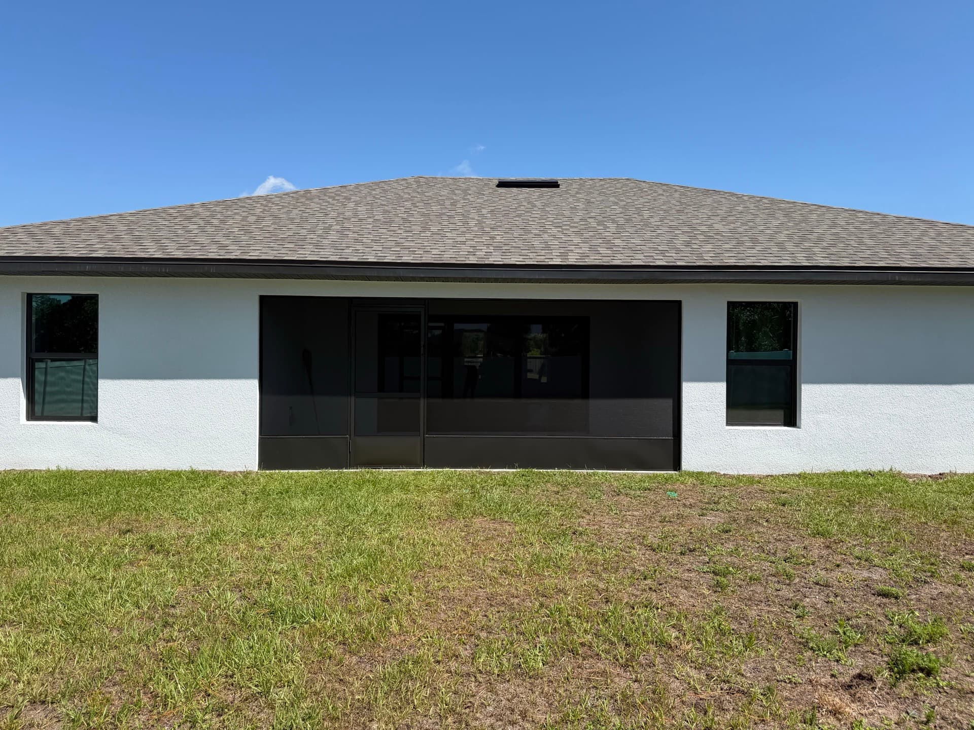 Screened porch enclosure installed on the back of a Brevard County home